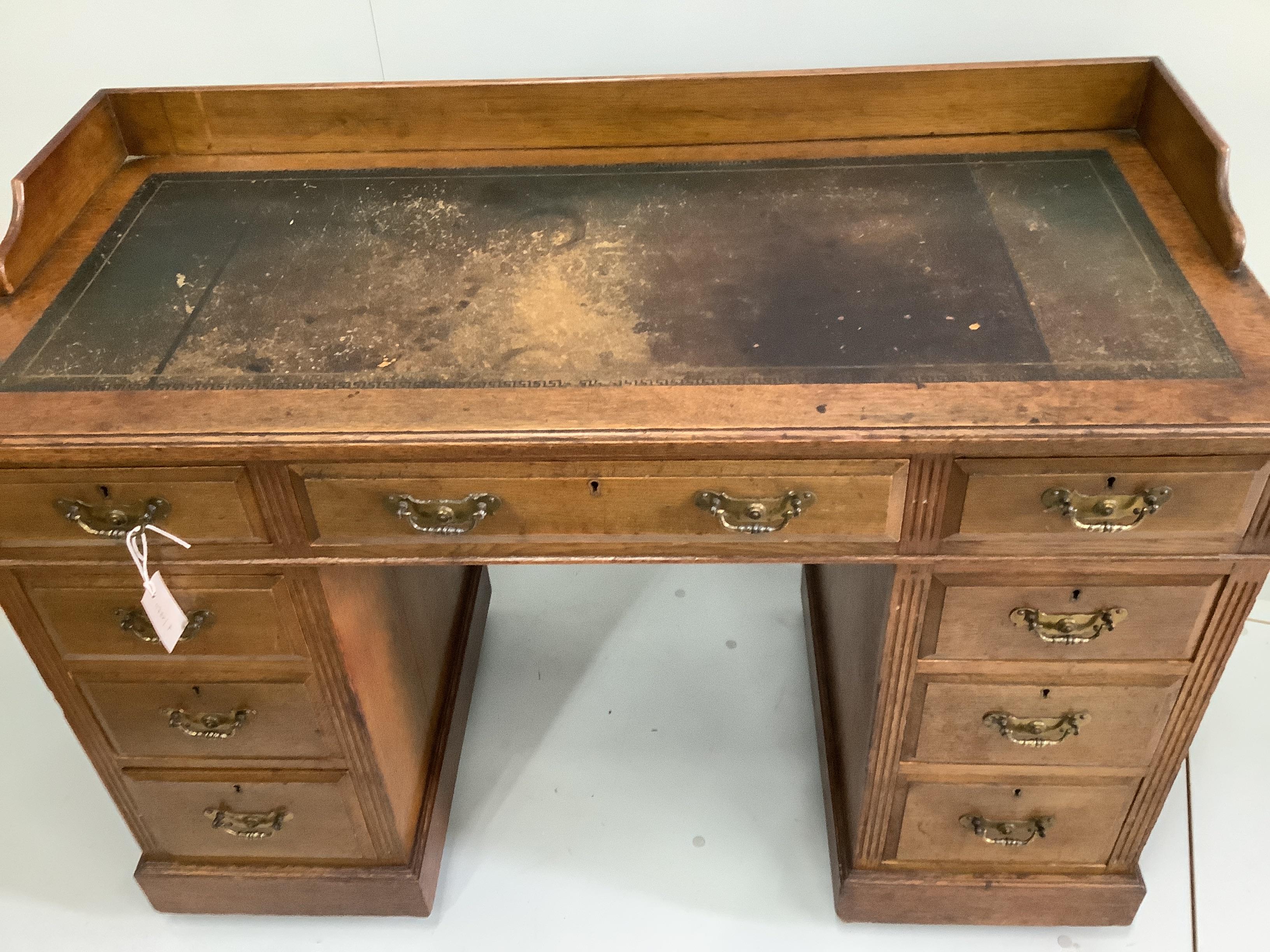 A late Victorian oak pedestal desk, width 114cm, depth 53cm, height 84cm
